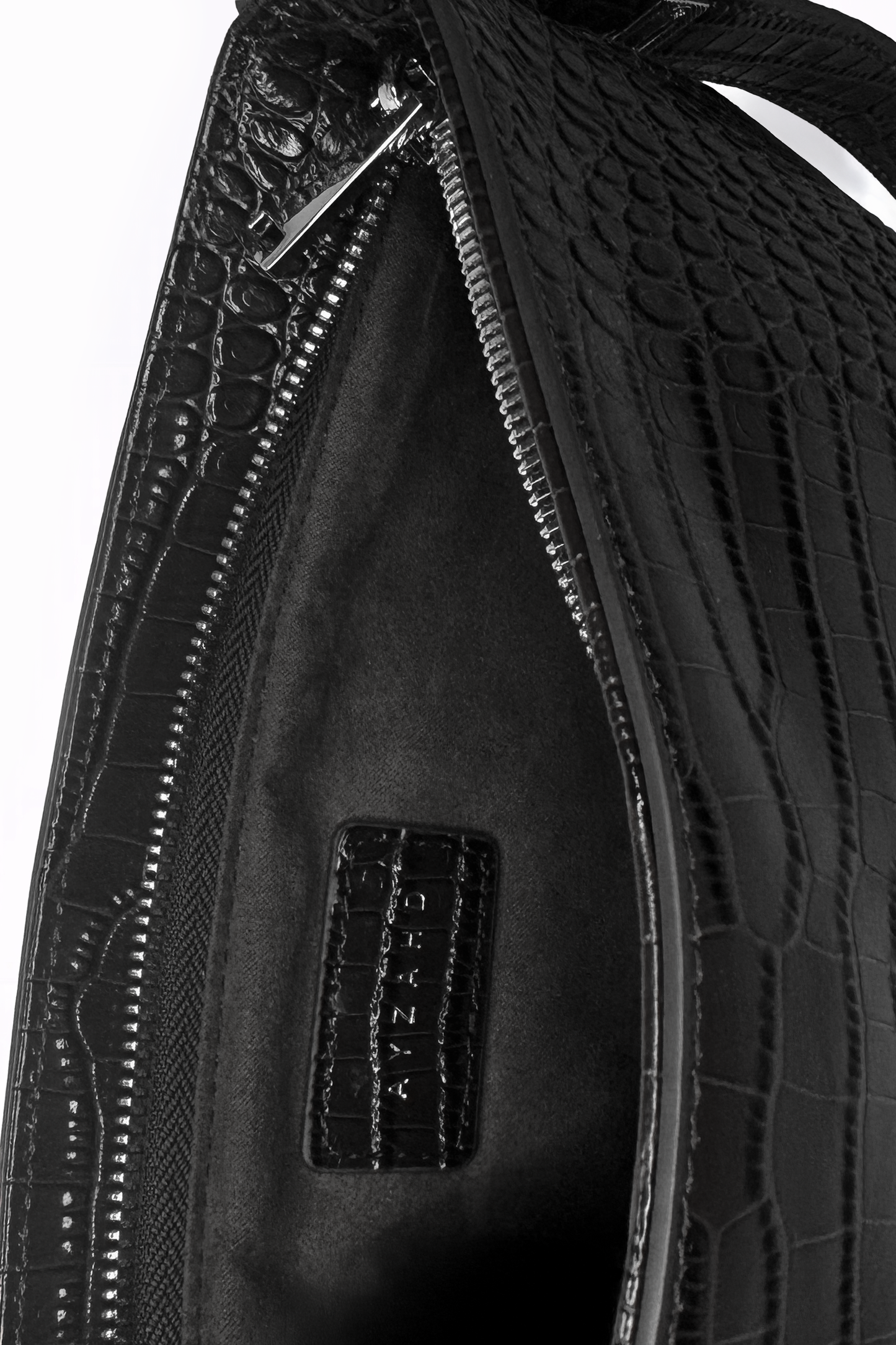 Uncompromising precision in every curve. The Avenue Bag by AYZAHD isolates the beauty of futuristic design and rich croco-embossed calfskin texture. Designed in Dubai for the avant-garde.