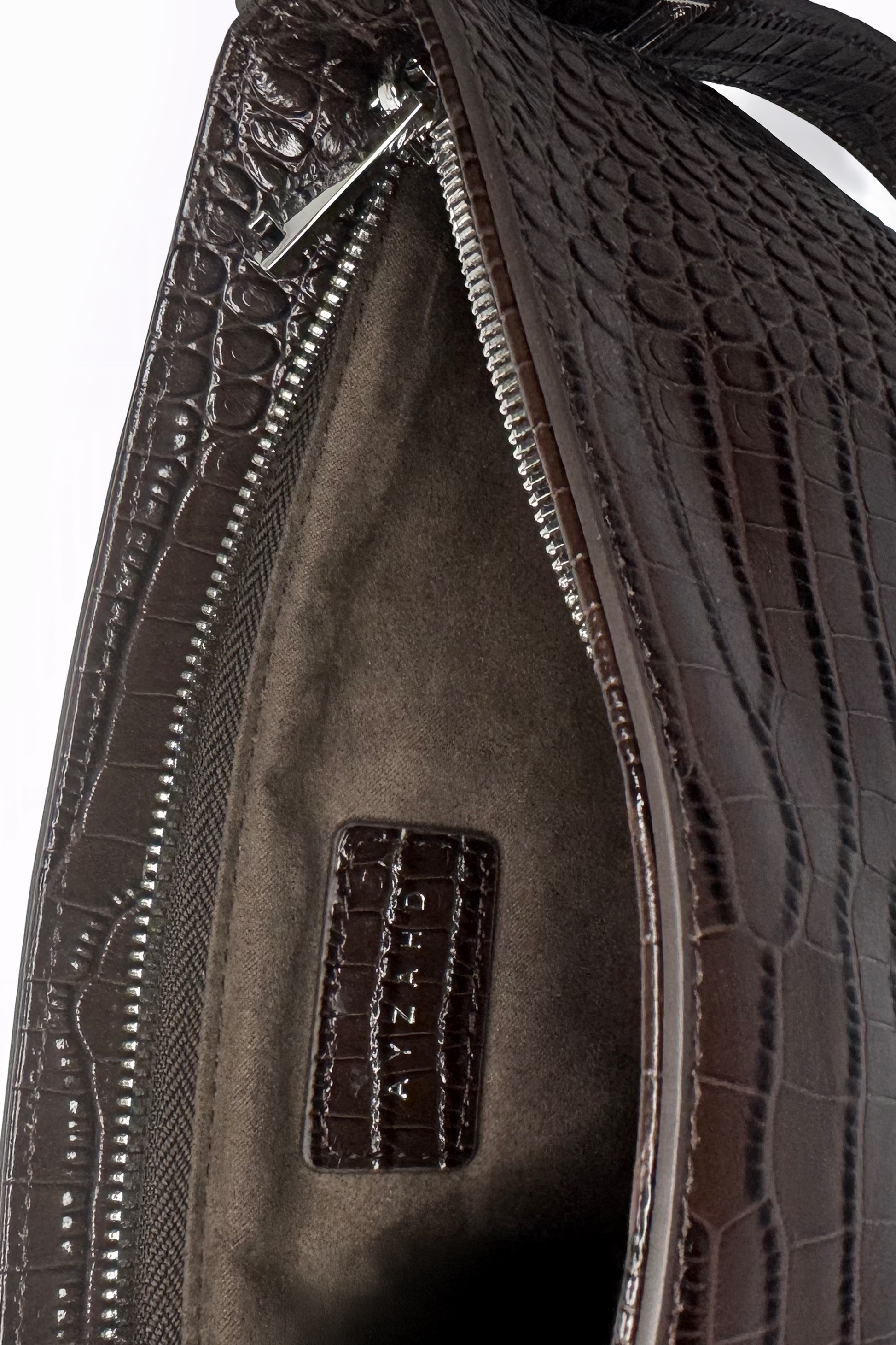 Uncompromising precision in every curve. The Avenue Bag by AYZAHD highlights the striking contrast of futuristic design and rich Sable Ember croco-embossed calfskin texture. Designed in Dubai for the avant-garde.