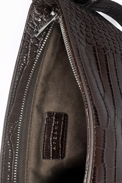 Uncompromising precision in every curve. The Avenue Bag by AYZAHD highlights the striking contrast of futuristic design and rich Sable Ember croco-embossed calfskin texture. Designed in Dubai for the avant-garde.