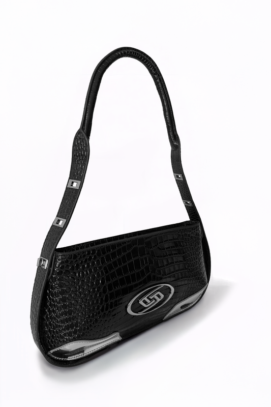The Avenue Bag by AYZAHD captures the light on its rich, deep black croco-embossed calfskin. A sculptural silhouette designed in Dubai with quiet, uncompromising intention
