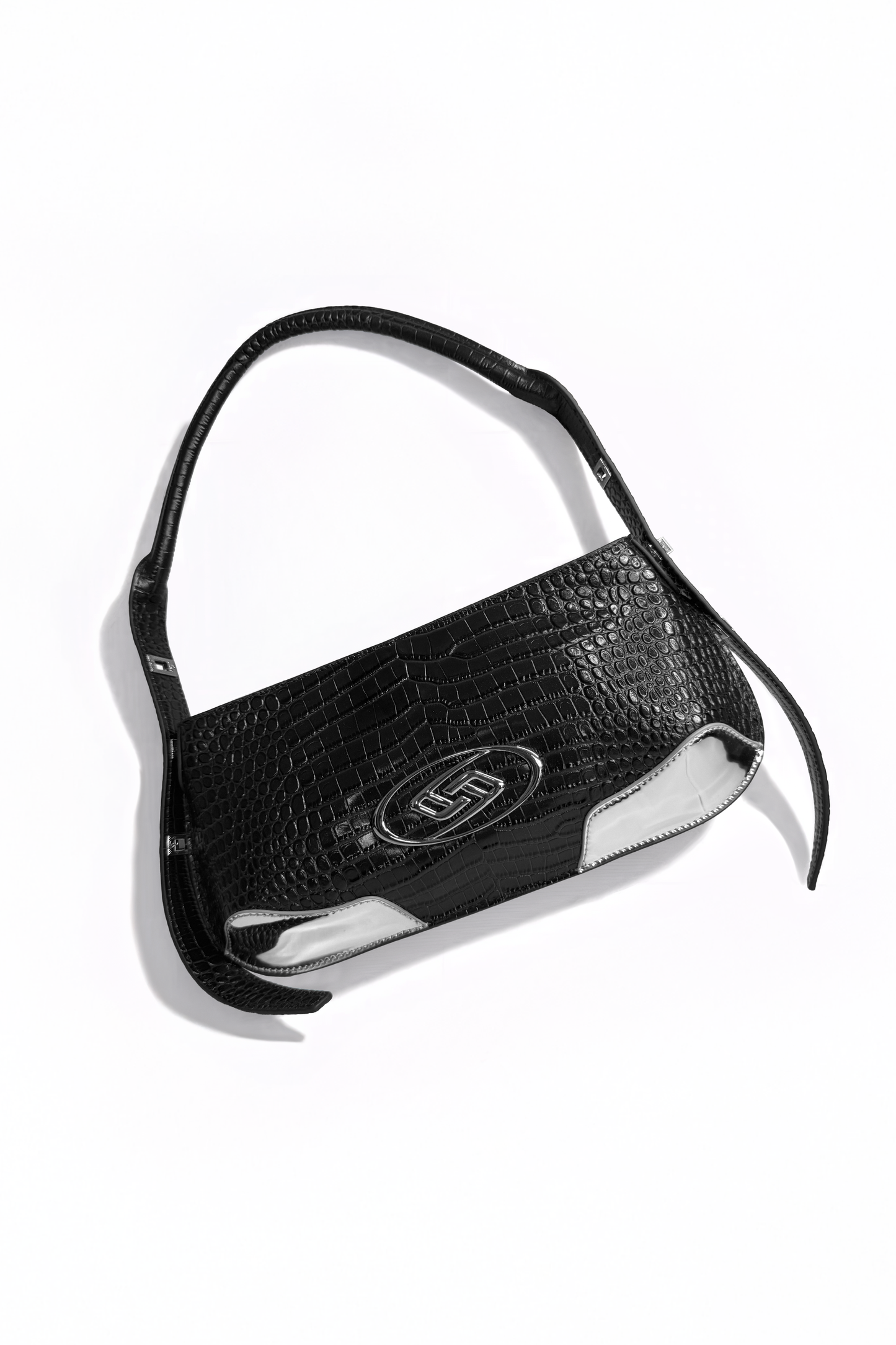 The Avenue Bag by AYZAHD in motion. Bringing raw luxury and sharp, geometric forms to the contemporary wardrobe. Crafted from premium croco-embossed calfskin and designed in Dubai.