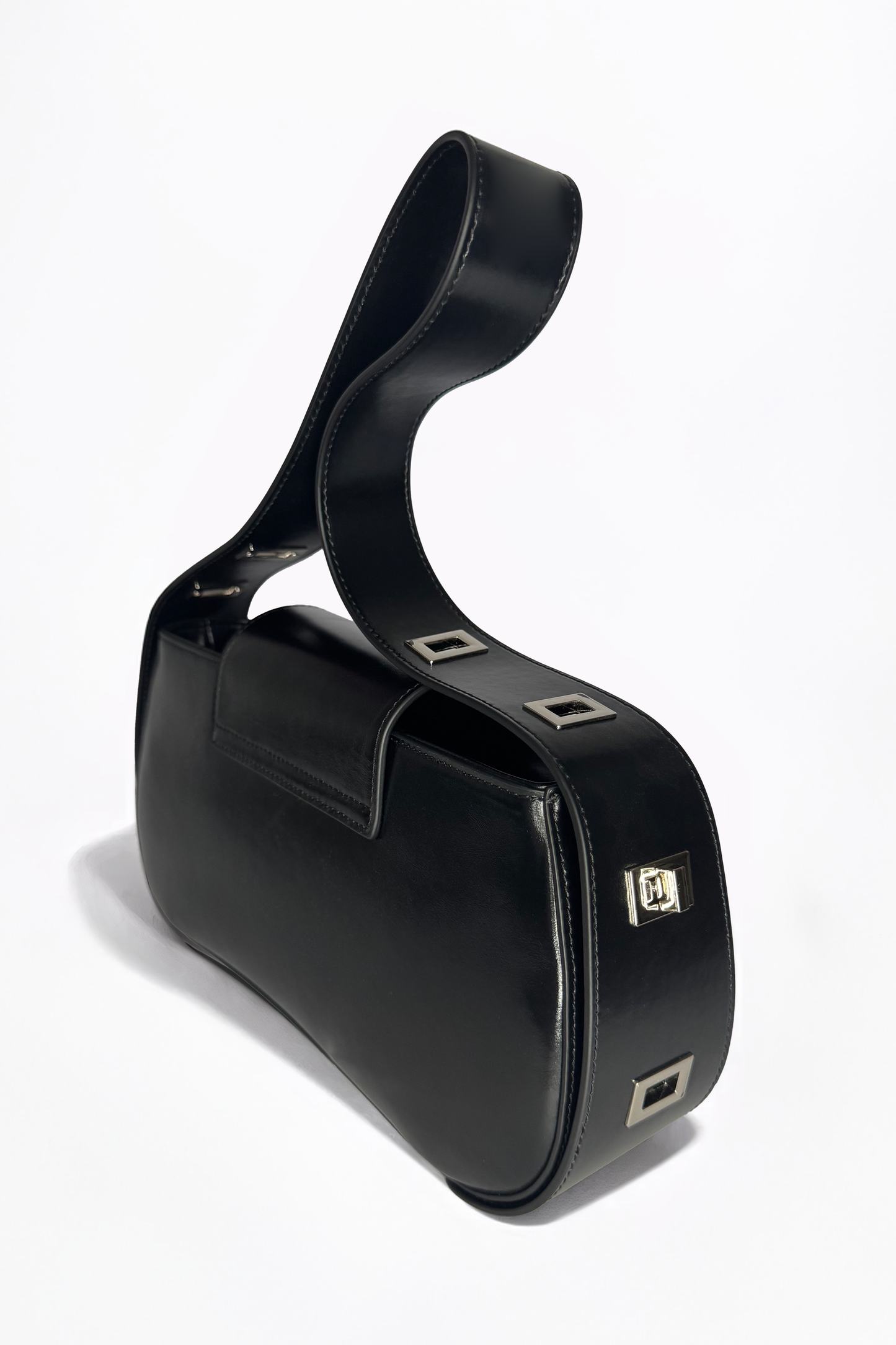 Defined by its rigid yet fluid elegance, The Downtown Bag by AYZAHD in Obsidian Veil reimagines modern leatherwork. An architectural masterpiece in grained oiled soft calfskin, proudly conceived and designed in Dubai.