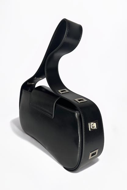 Defined by its rigid yet fluid elegance, The Downtown Bag by AYZAHD in Obsidian Veil reimagines modern leatherwork. An architectural masterpiece in grained oiled soft calfskin, proudly conceived and designed in Dubai.