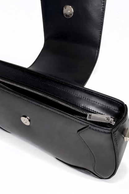 Uncompromising precision in every curve. The Downtown Bag by AYZAHD highlights the striking contrast of futuristic design and the rich, organic texture of Obsidian Veil grained oiled soft calfskin. Designed in Dubai for the avant-garde.